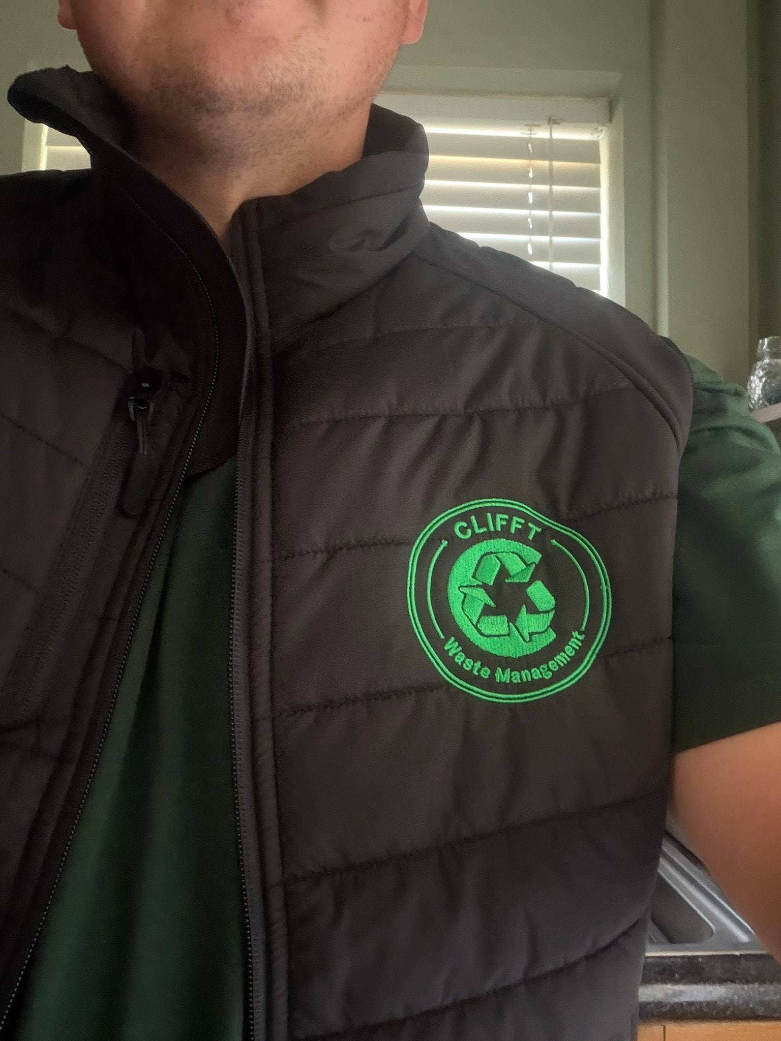 CLIFFT waste-clearance team member in branded safety vest